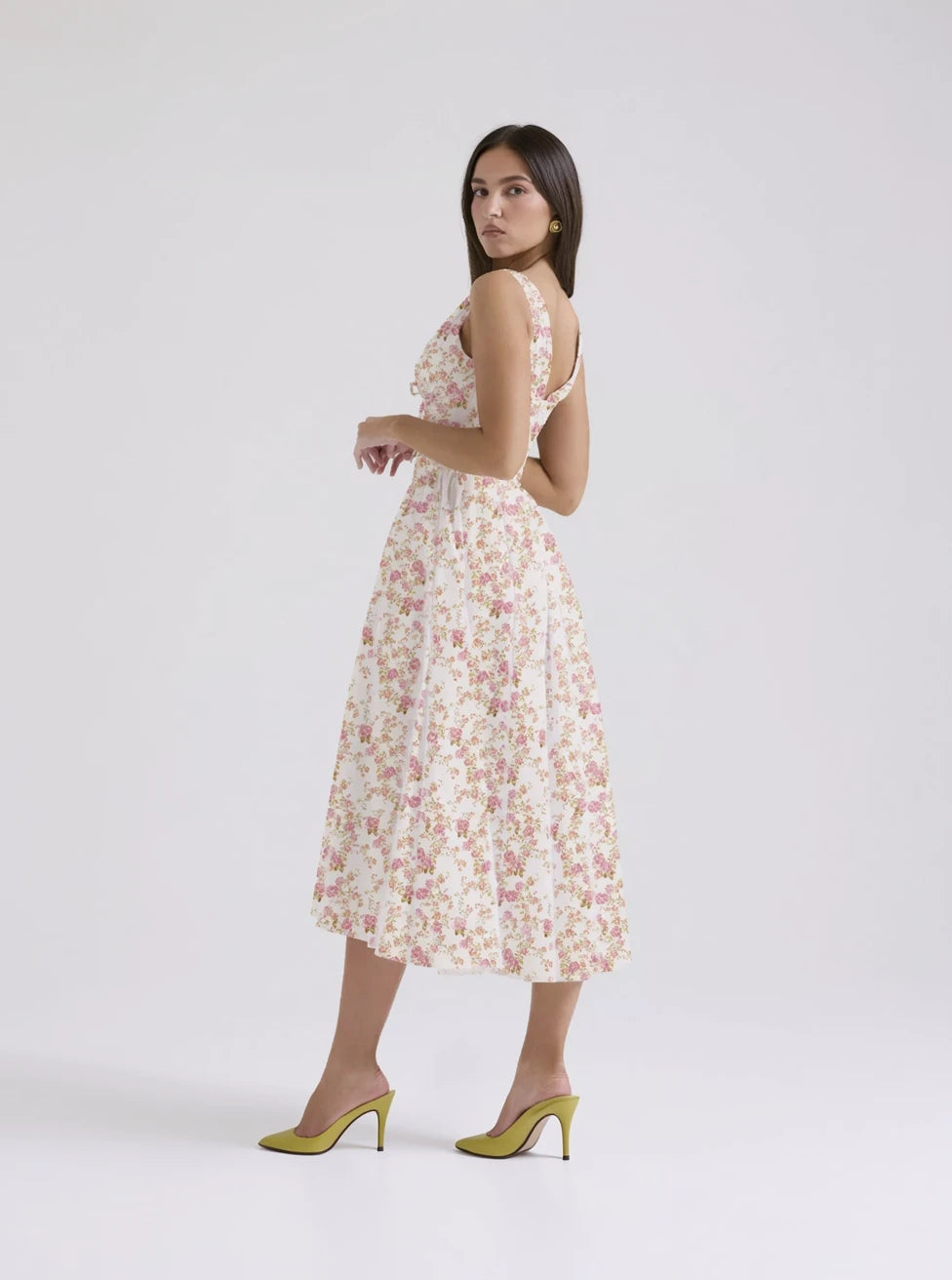 Woman wearing a floral dress on a white background