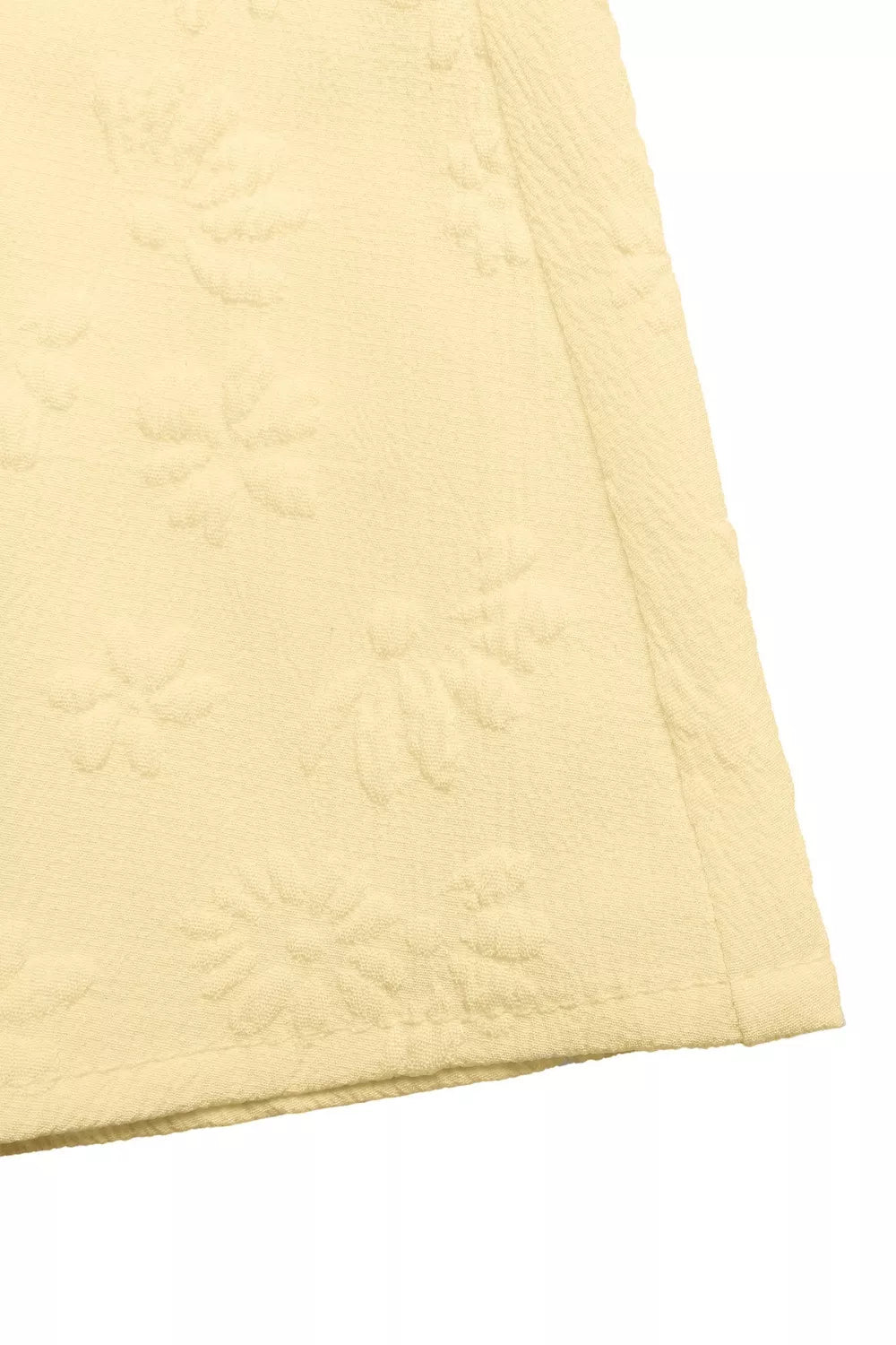 yellow quilted fabric on a white background