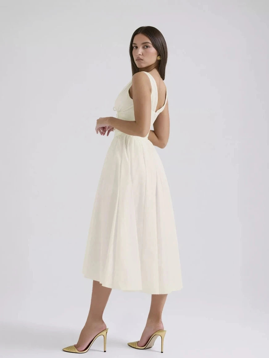 Woman wearing a white dress on a plain background