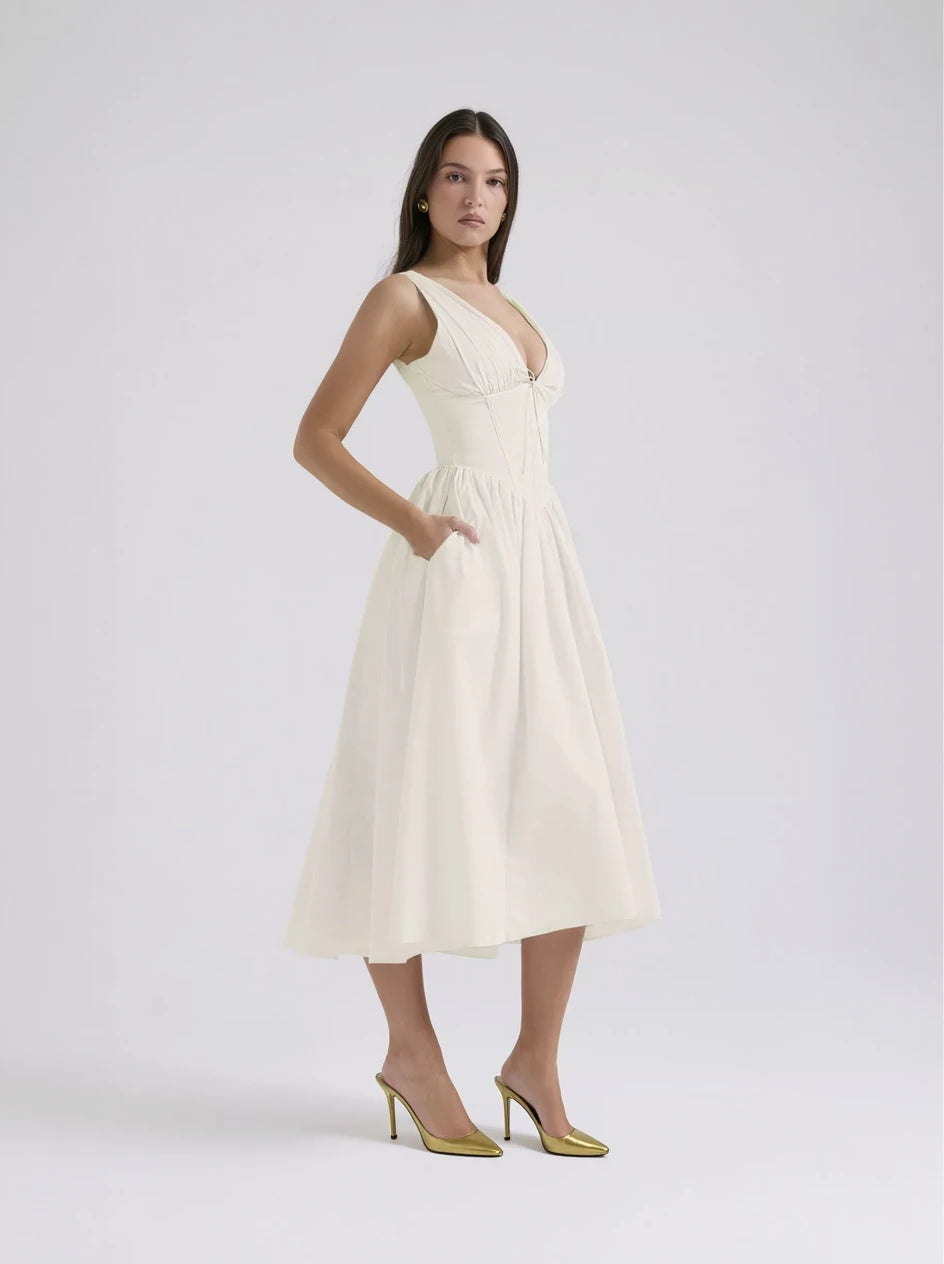 Woman wearing a white one-shoulder dress on a light gray background