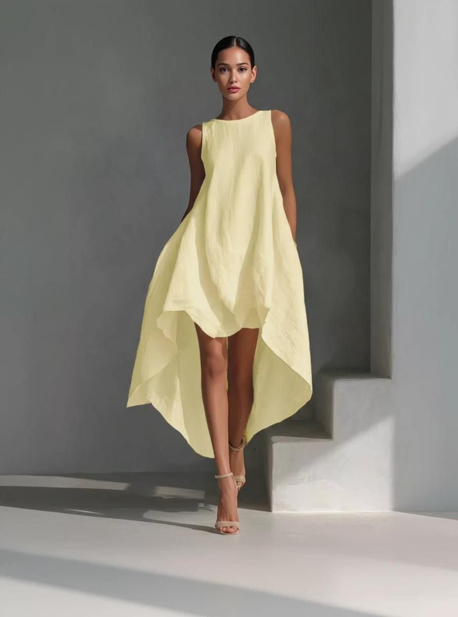 Woman wearing a light yellow dress against a gray background