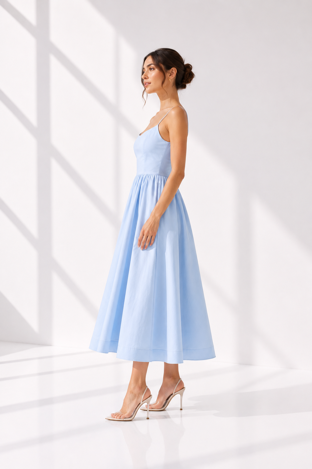 Woman wearing a light blue dress against a white background