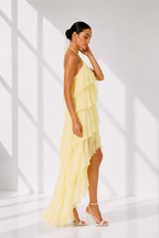Woman wearing a yellow dress in a bright, minimalistic setting