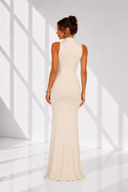 Woman wearing a white evening gown in a bright, minimalistic setting