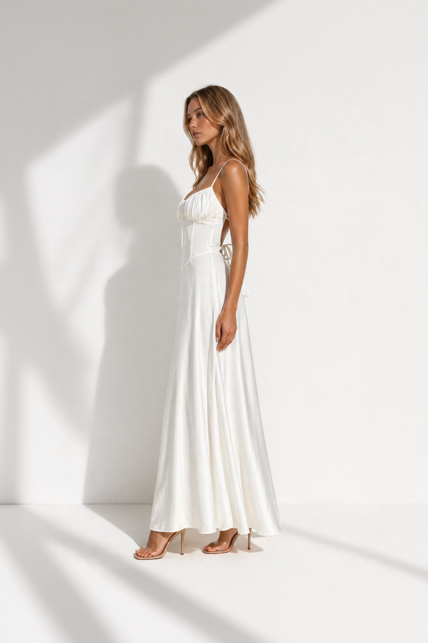 Woman wearing a white dress against a white background