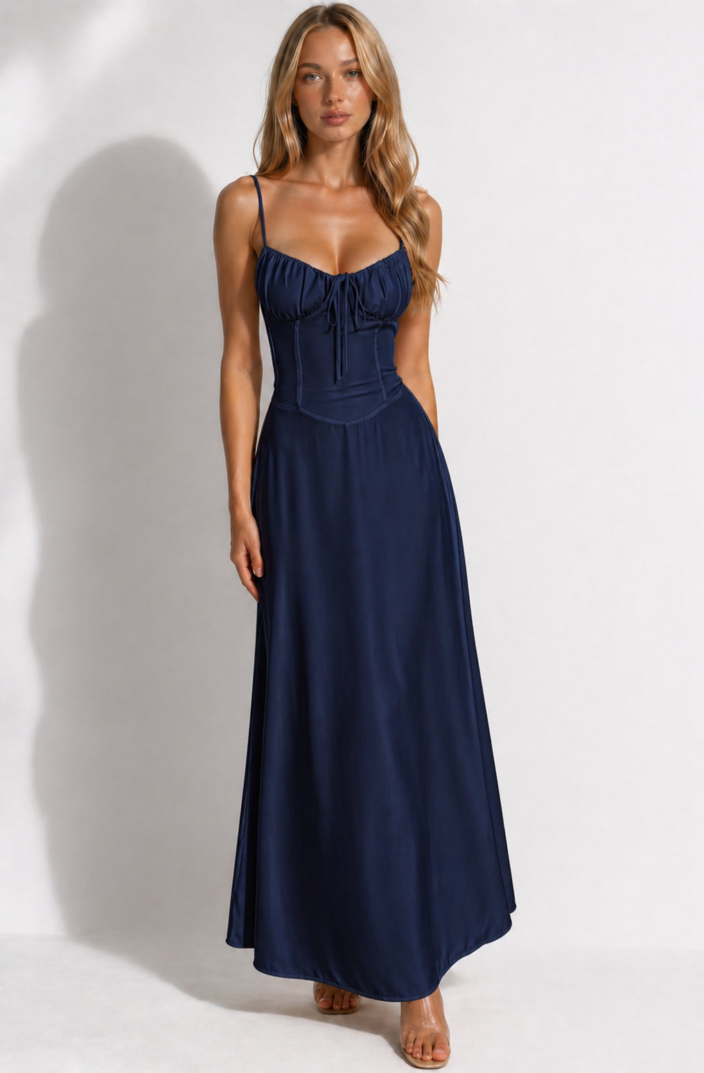 Woman wearing a navy blue dress against a white background