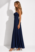 Woman wearing a navy blue dress against a white background