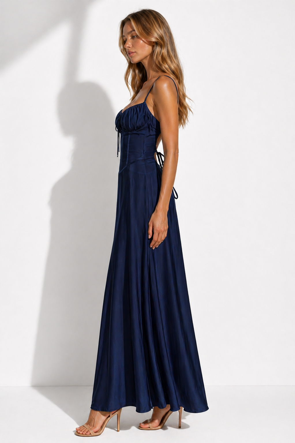 Woman wearing a navy blue dress against a white background