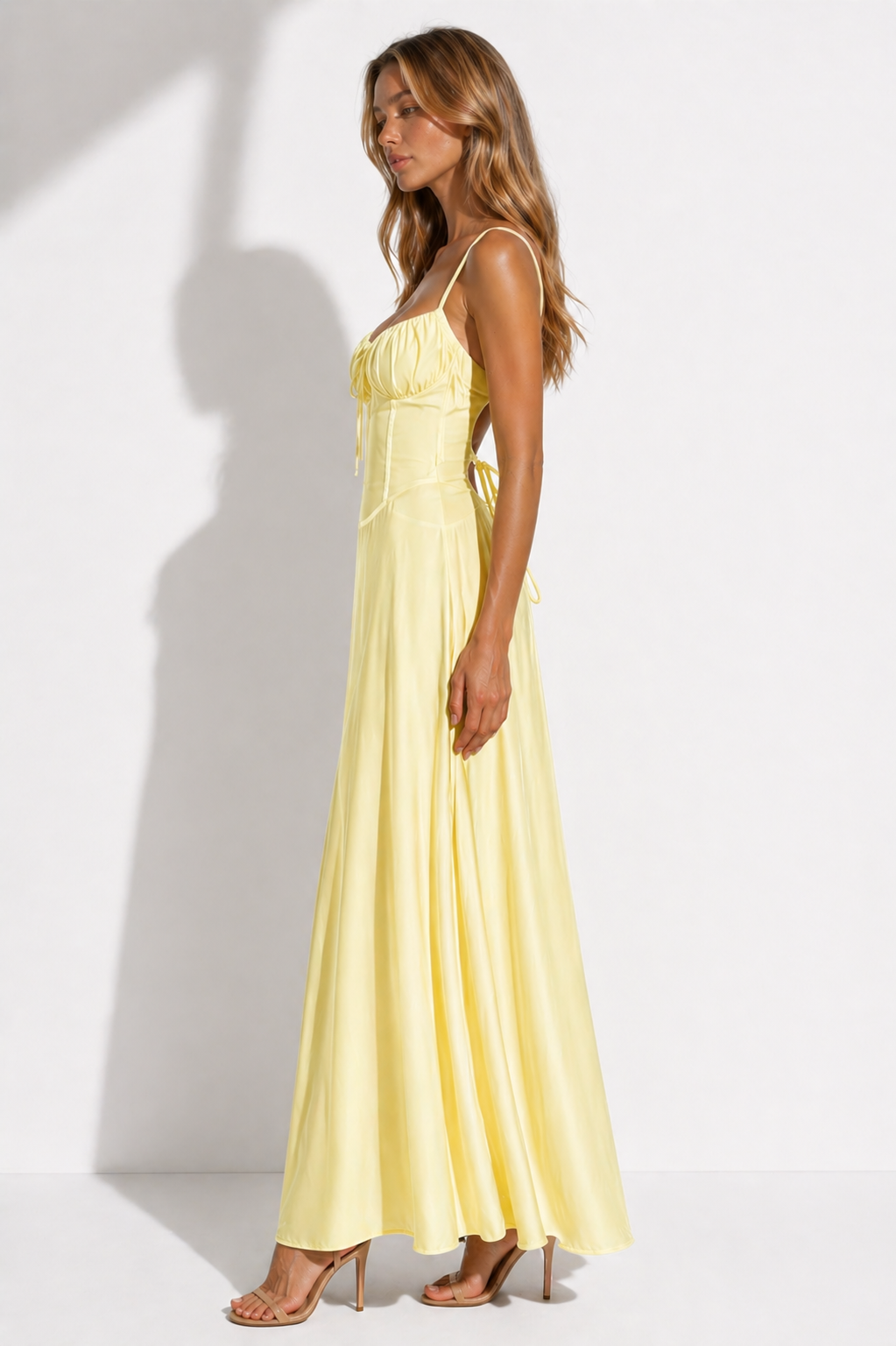 Woman wearing a yellow dress against a white background