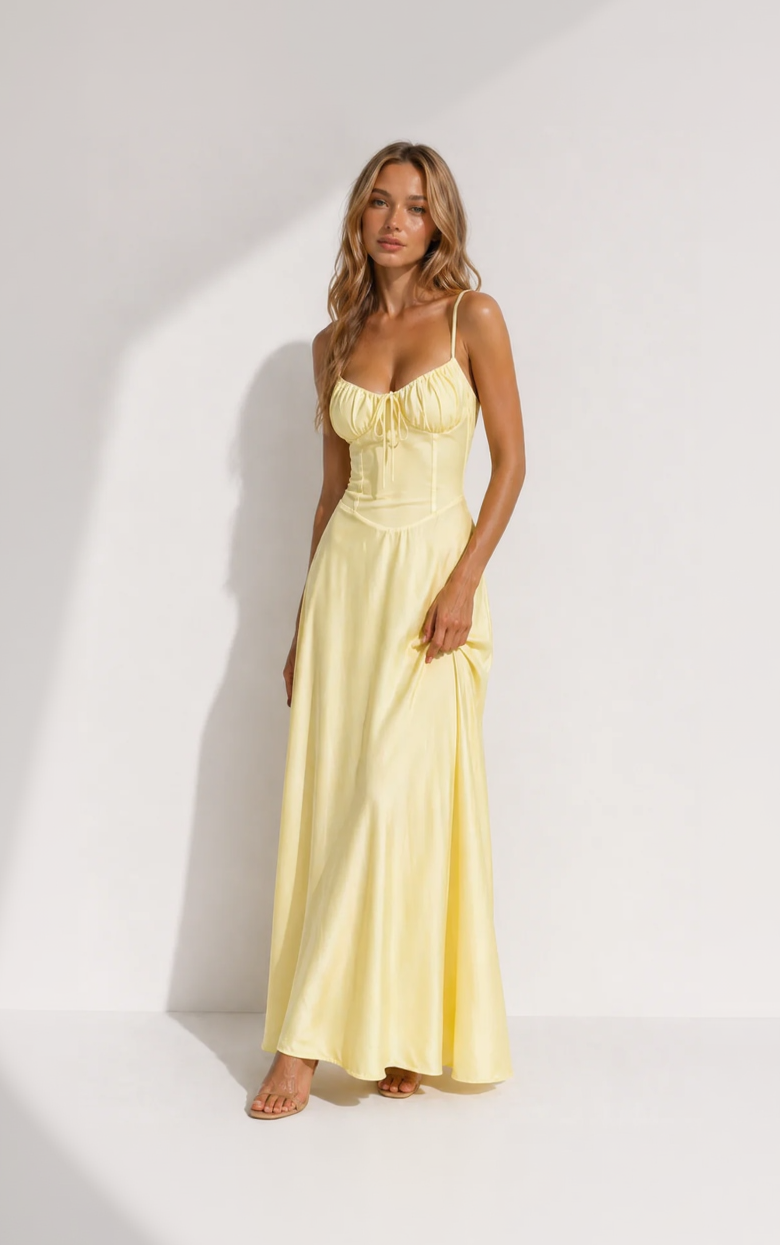 Woman wearing a yellow dress against a white background