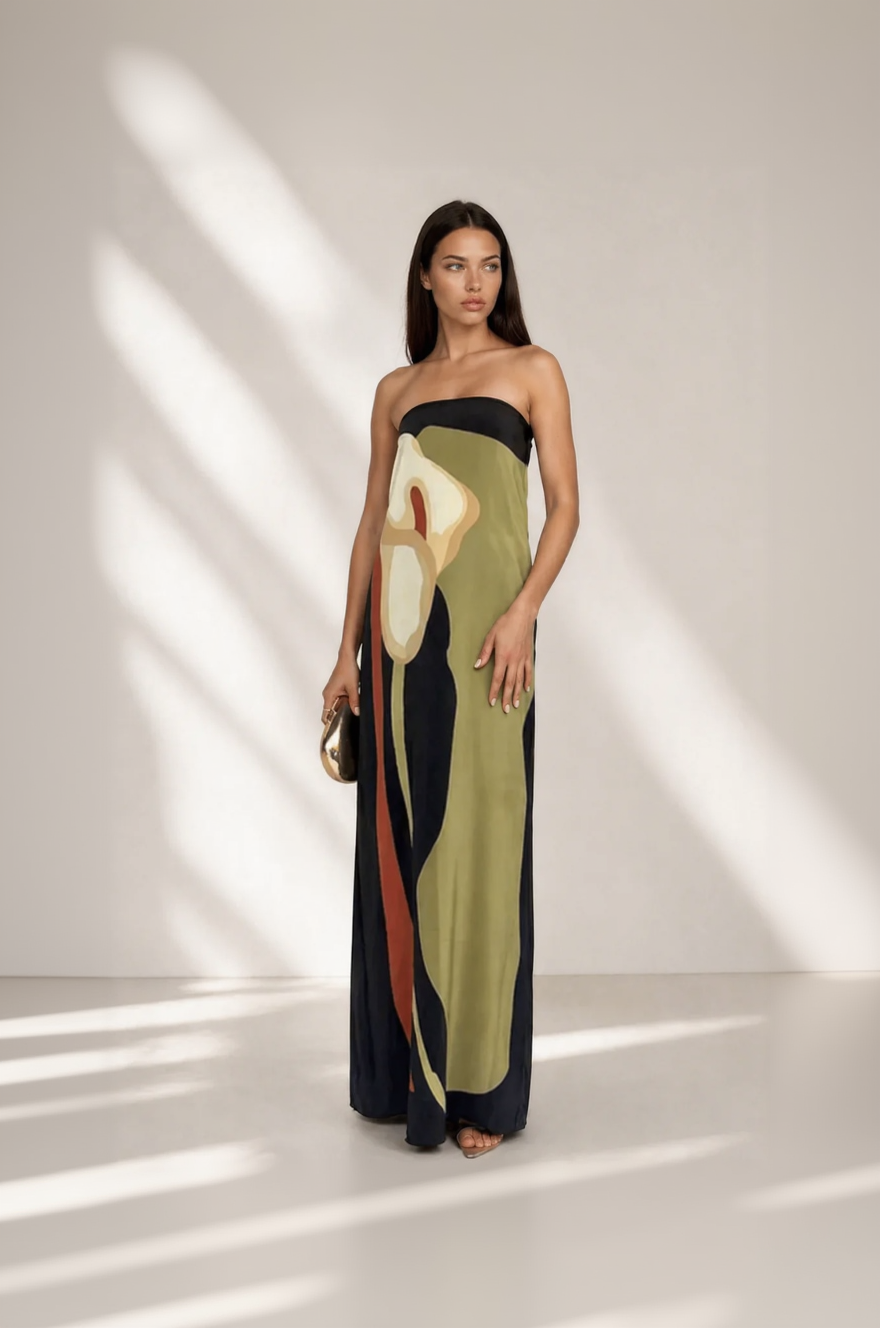 Woman wearing a strapless dress with abstract design on a white background