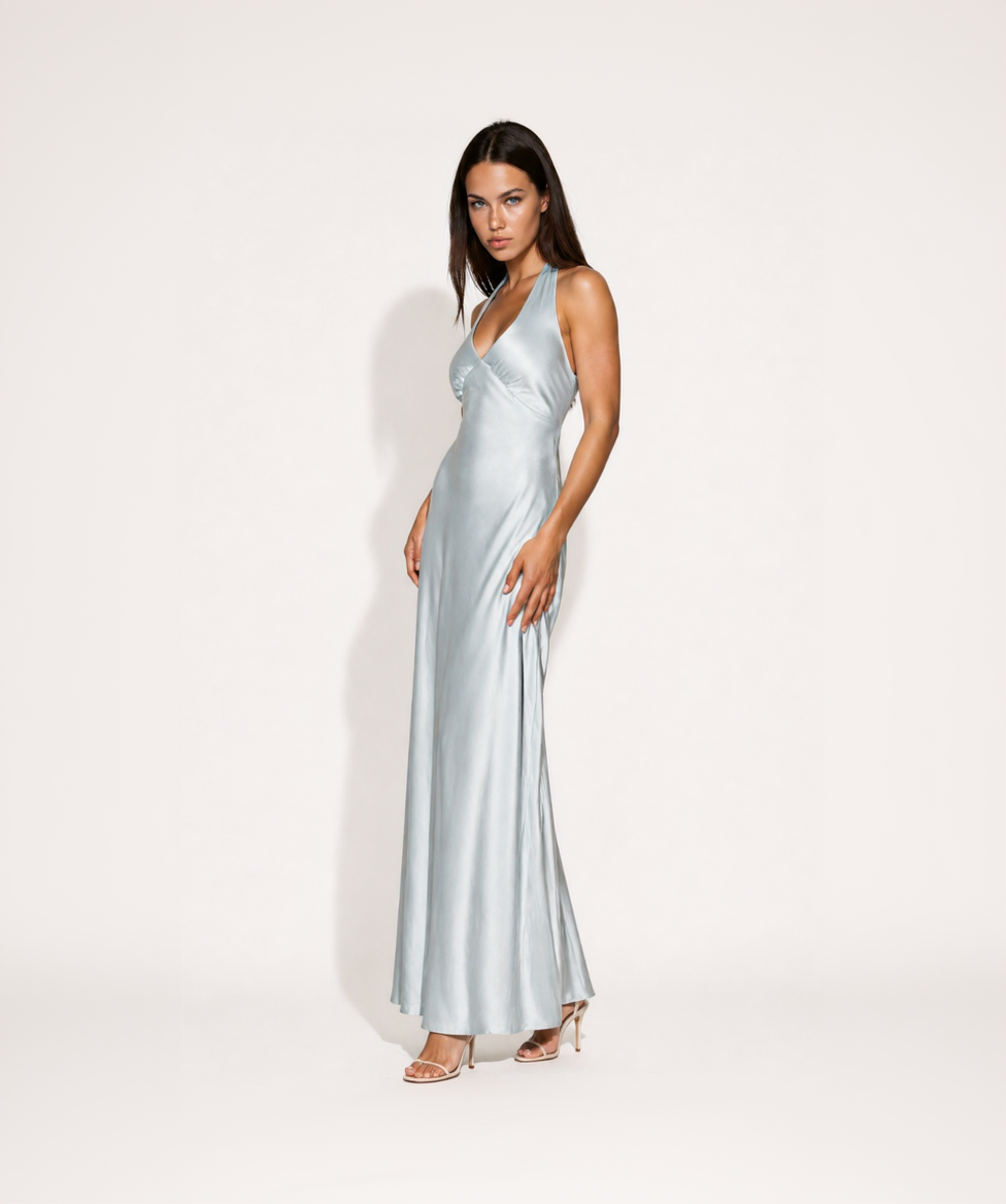 Woman wearing a silver evening gown on a white background
