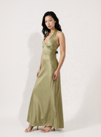 Woman wearing a green dress against a white background