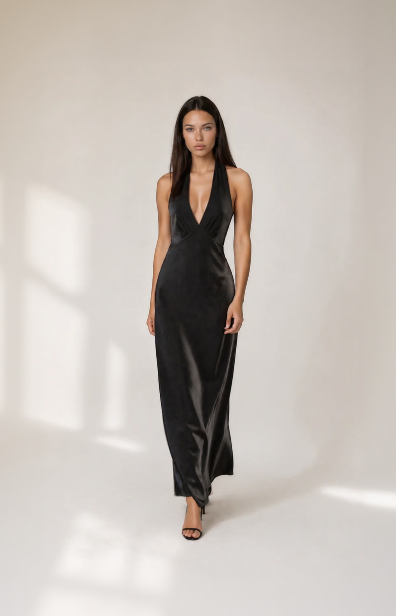 Woman wearing a black satin gown on a white background