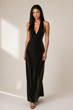 Woman wearing a black evening gown against a neutral background