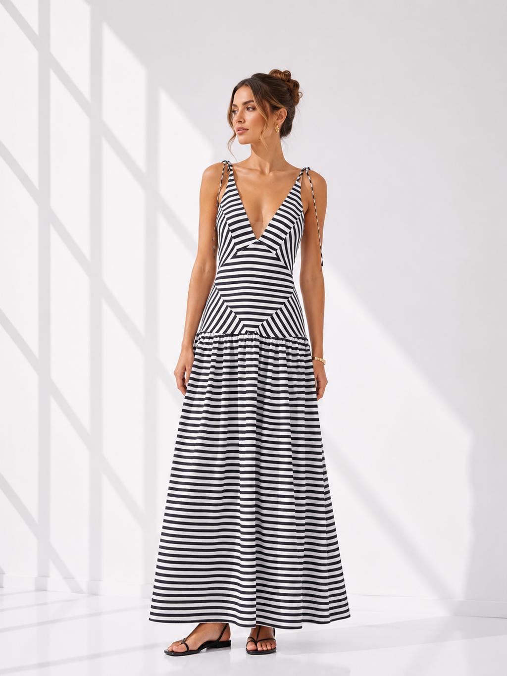 Woman wearing a black and white striped dress on a white background