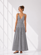 Woman wearing a black and white striped dress on a white background