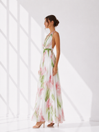 Woman wearing a floral dress in a bright, minimalistic setting