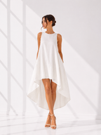 Woman wearing a white sleeveless dress against a white background
