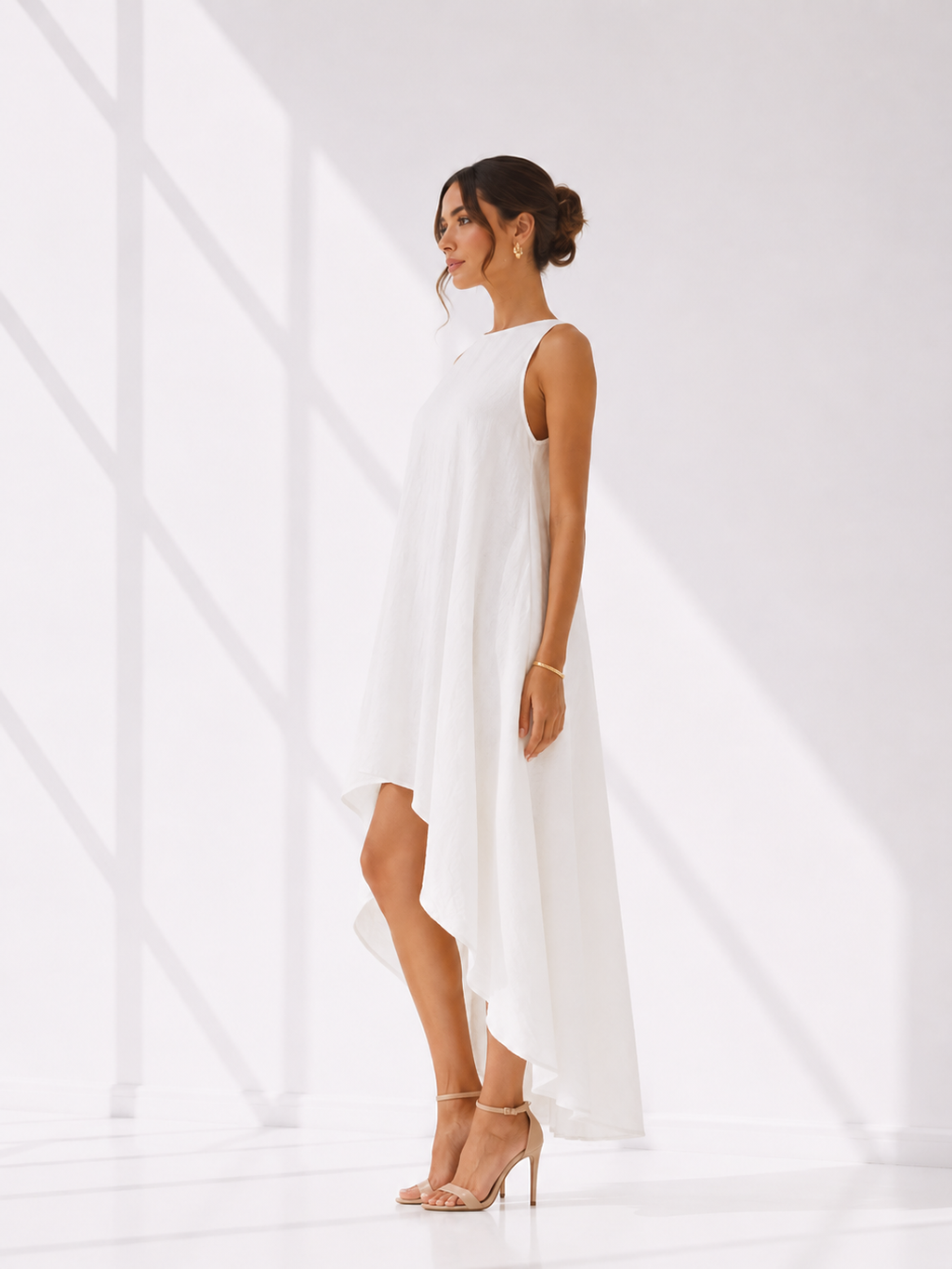 Woman wearing a white sleeveless dress against a white background