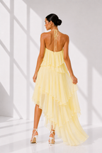 Woman wearing a yellow dress with a white background
