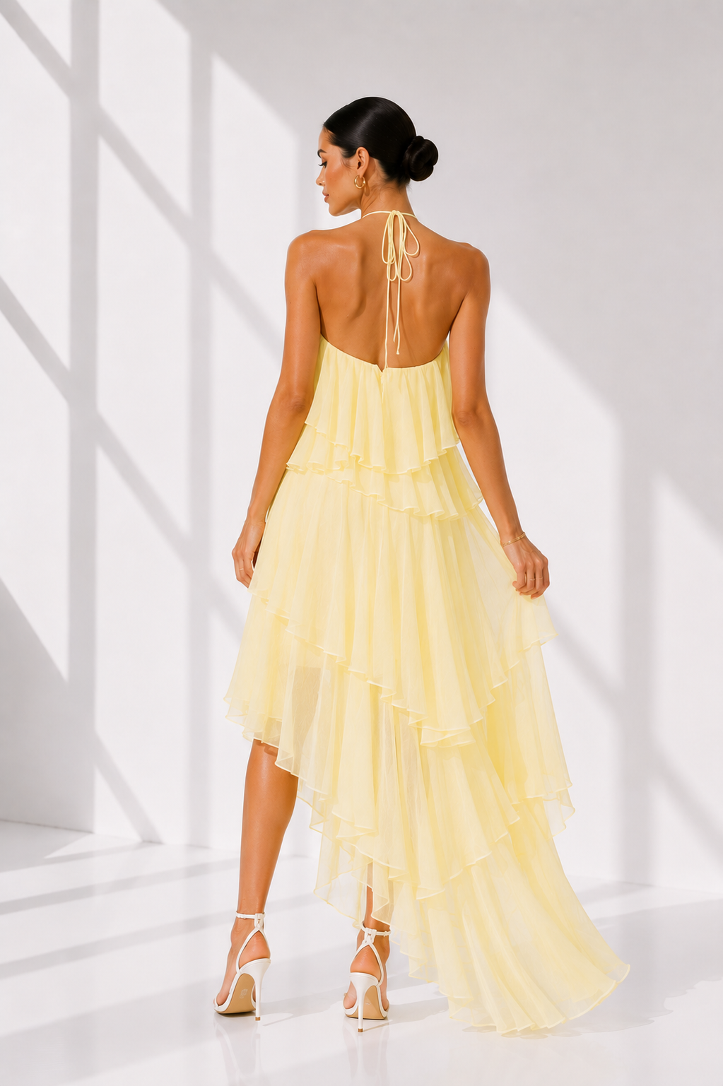Woman wearing a yellow dress with a white background