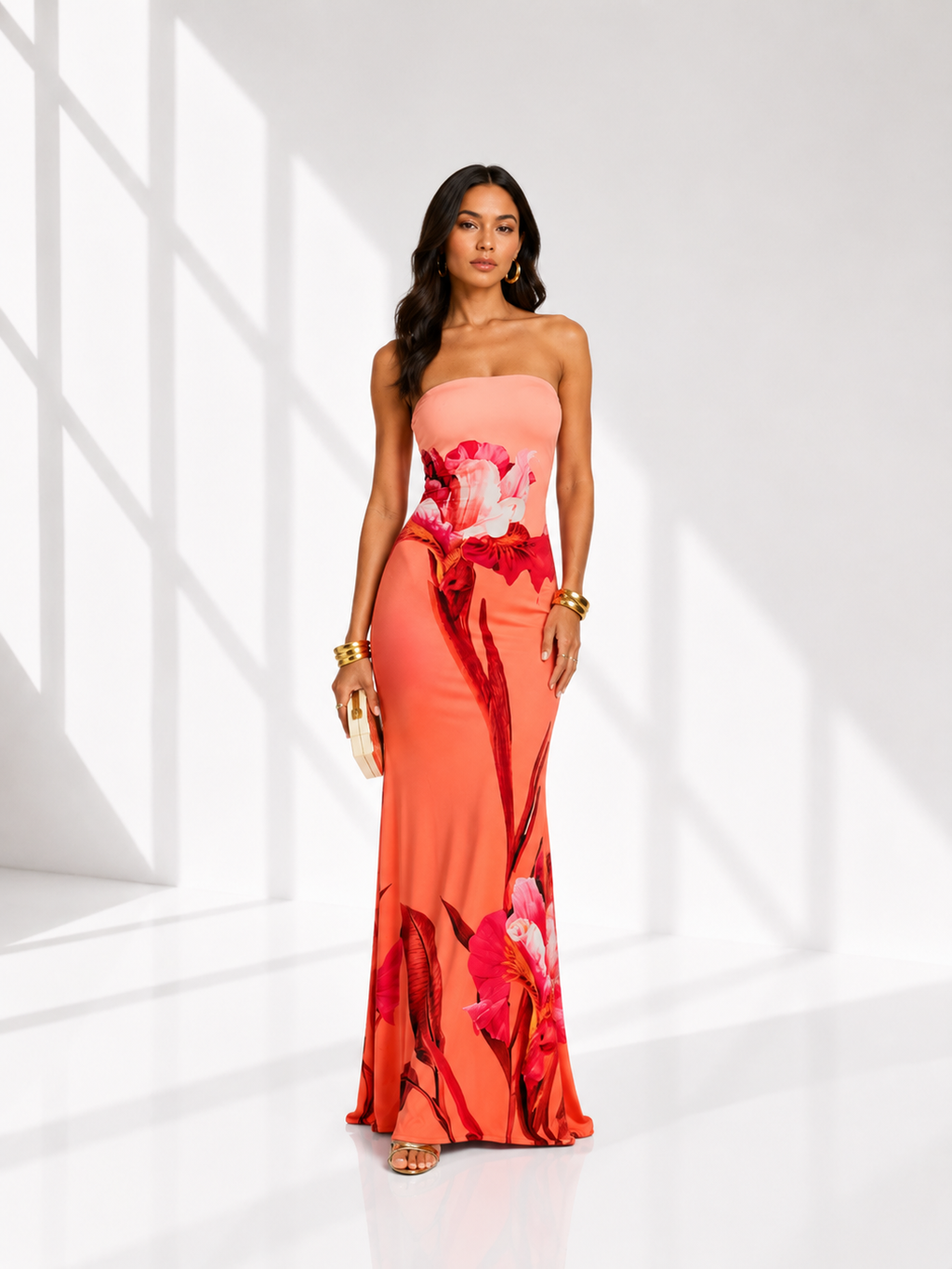 Woman wearing a strapless floral gown against a white background