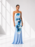 Woman wearing a strapless dress with blue floral pattern in a bright room