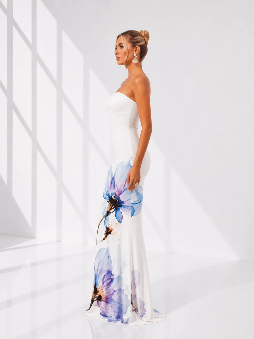 Woman wearing a strapless dress with floral design in a minimalistic setting