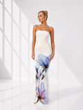 Woman wearing a strapless gown with floral design on a white background