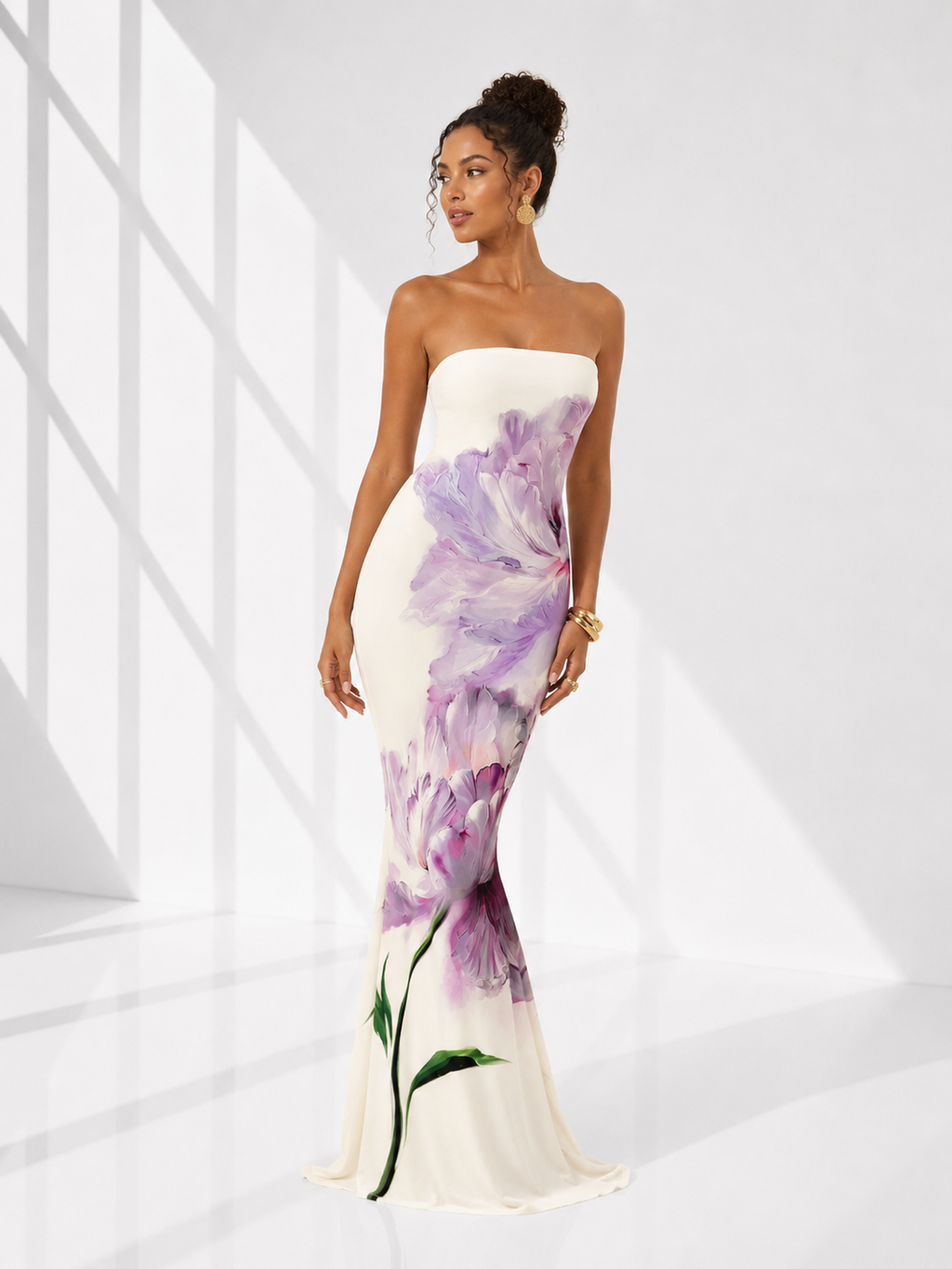 Woman wearing a strapless gown with floral design on a white background