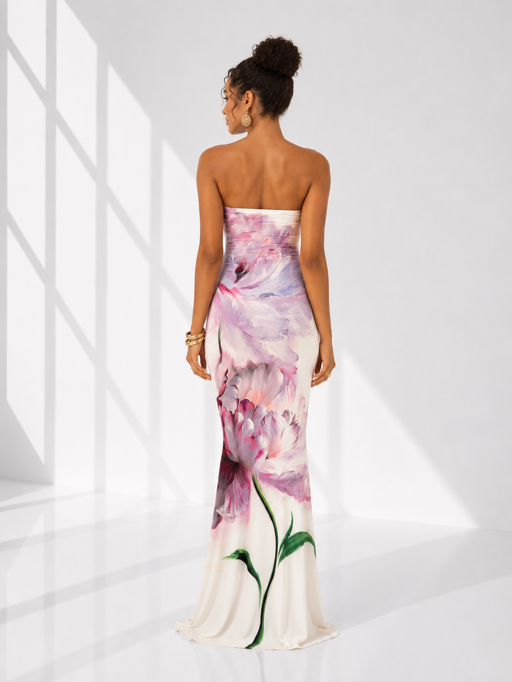 Woman wearing a strapless floral dress in a bright, minimalistic setting