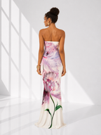 Woman wearing a strapless floral dress in a bright, minimalistic setting