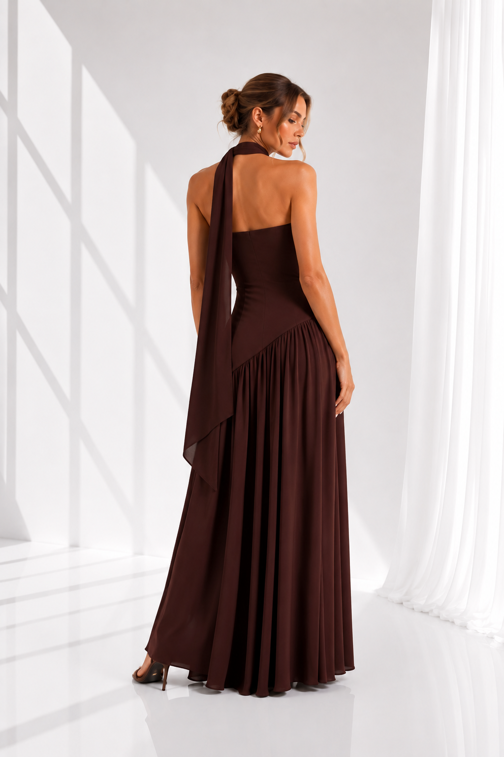 Woman wearing a brown evening gown in a white room