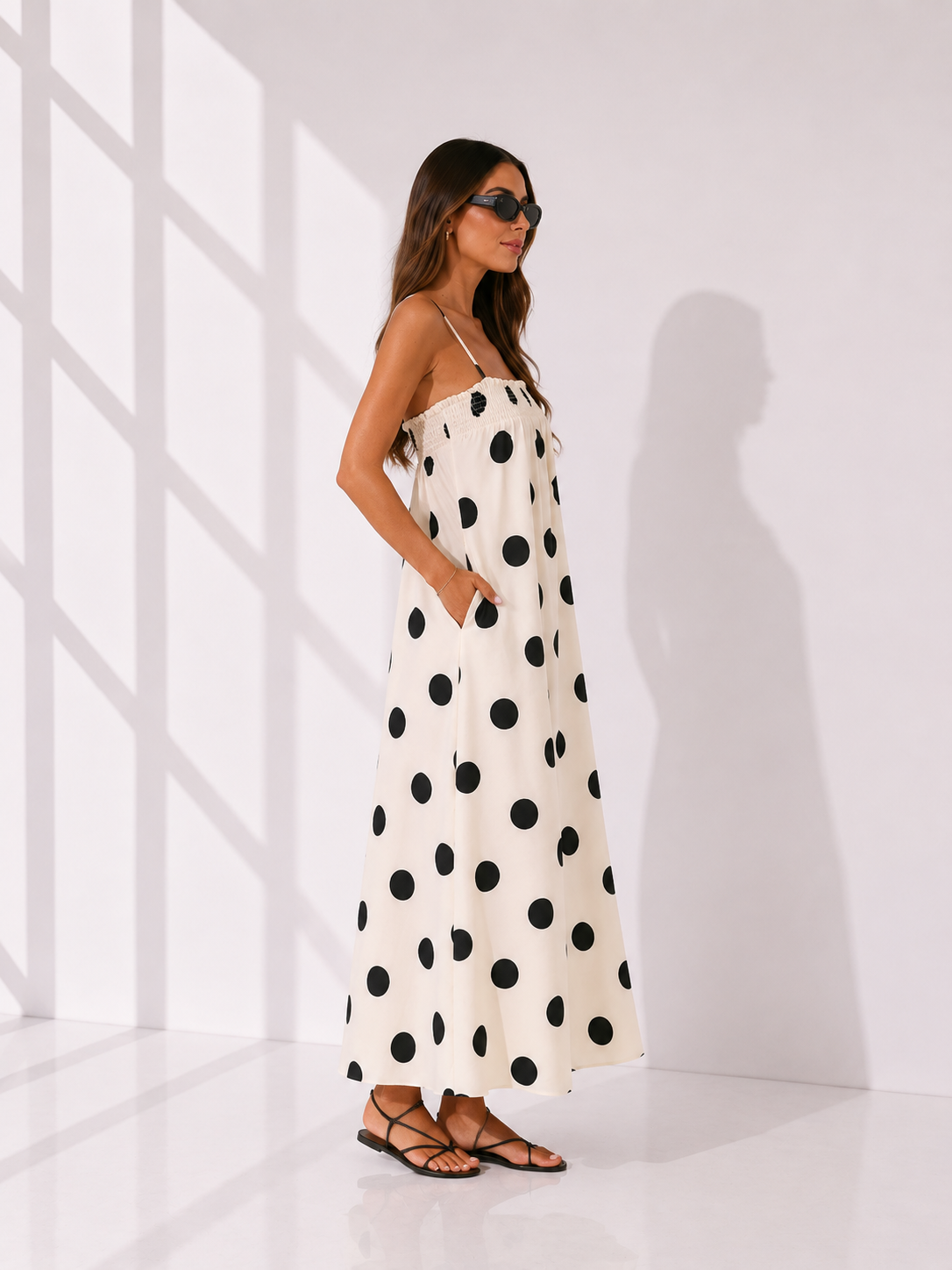 Woman wearing a polka dot dress in a minimalistic setting
