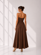 Woman wearing a brown dress with a white background