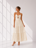 Woman wearing a polka dot dress in a bright room