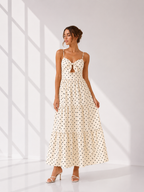 Woman wearing a polka dot dress in a bright room