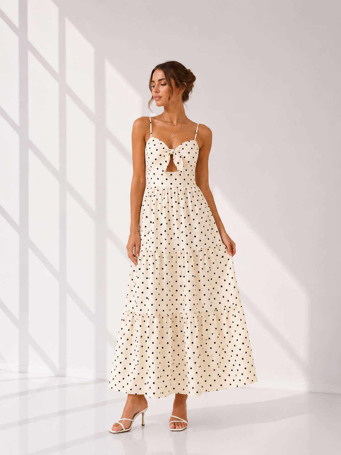 Woman wearing a polka dot dress in a bright room