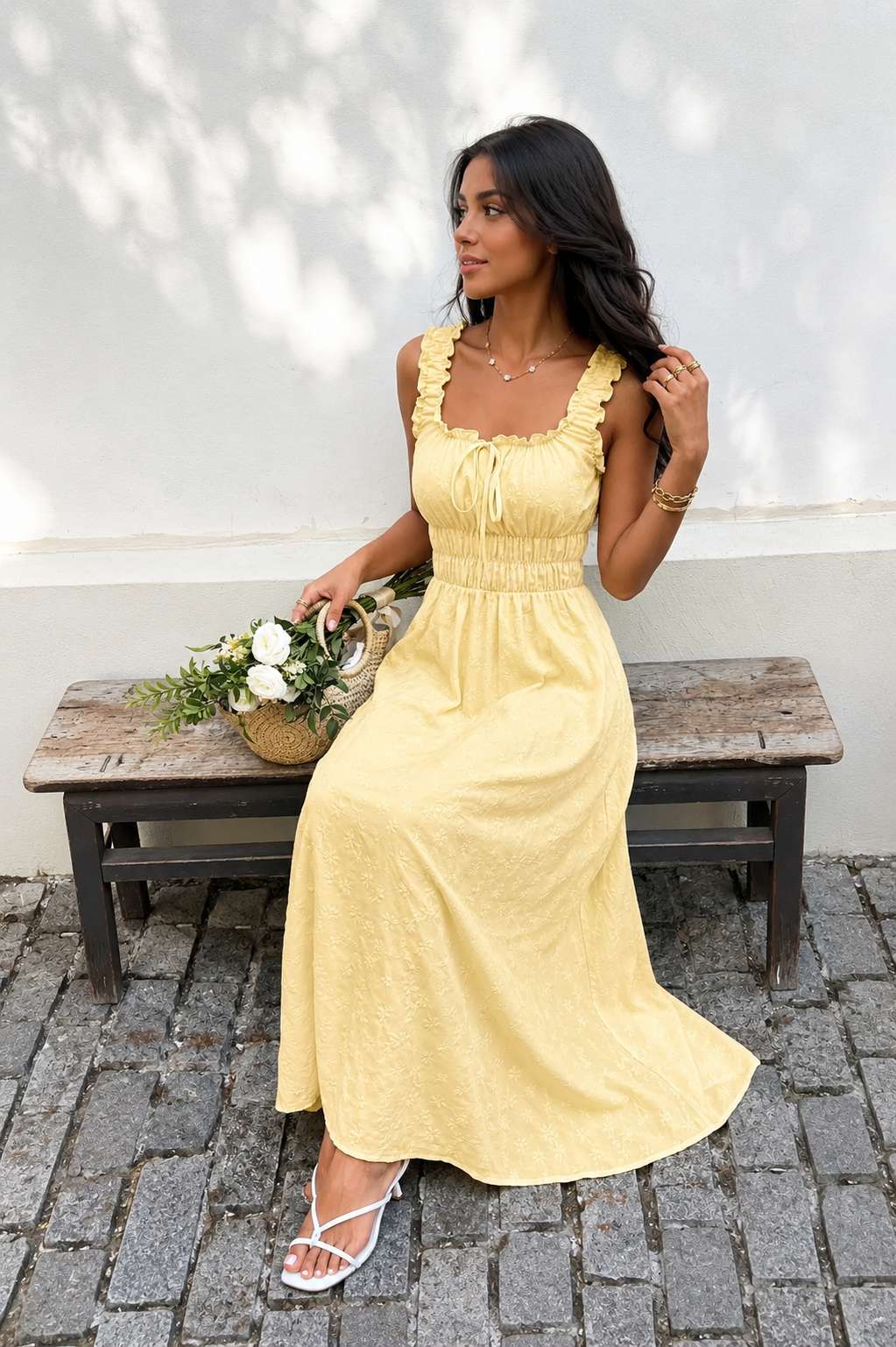 Lemon Frill Strap Tie-Front Smocked Waist Maxi Dress sat down on a bench