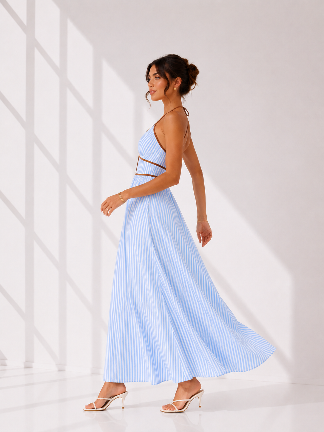 Woman wearing a light blue dress with a white background