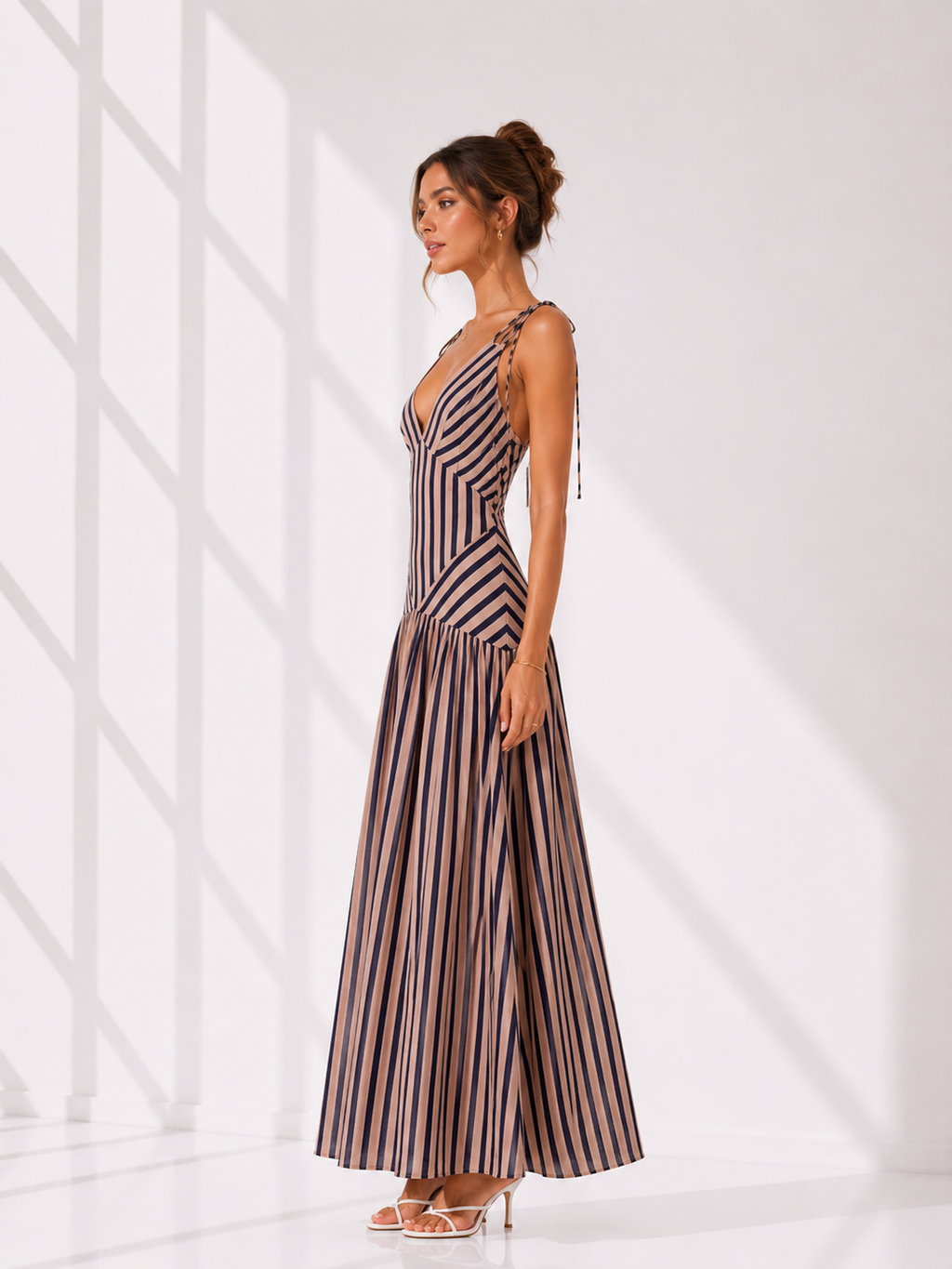 Woman wearing a striped dress against a white background