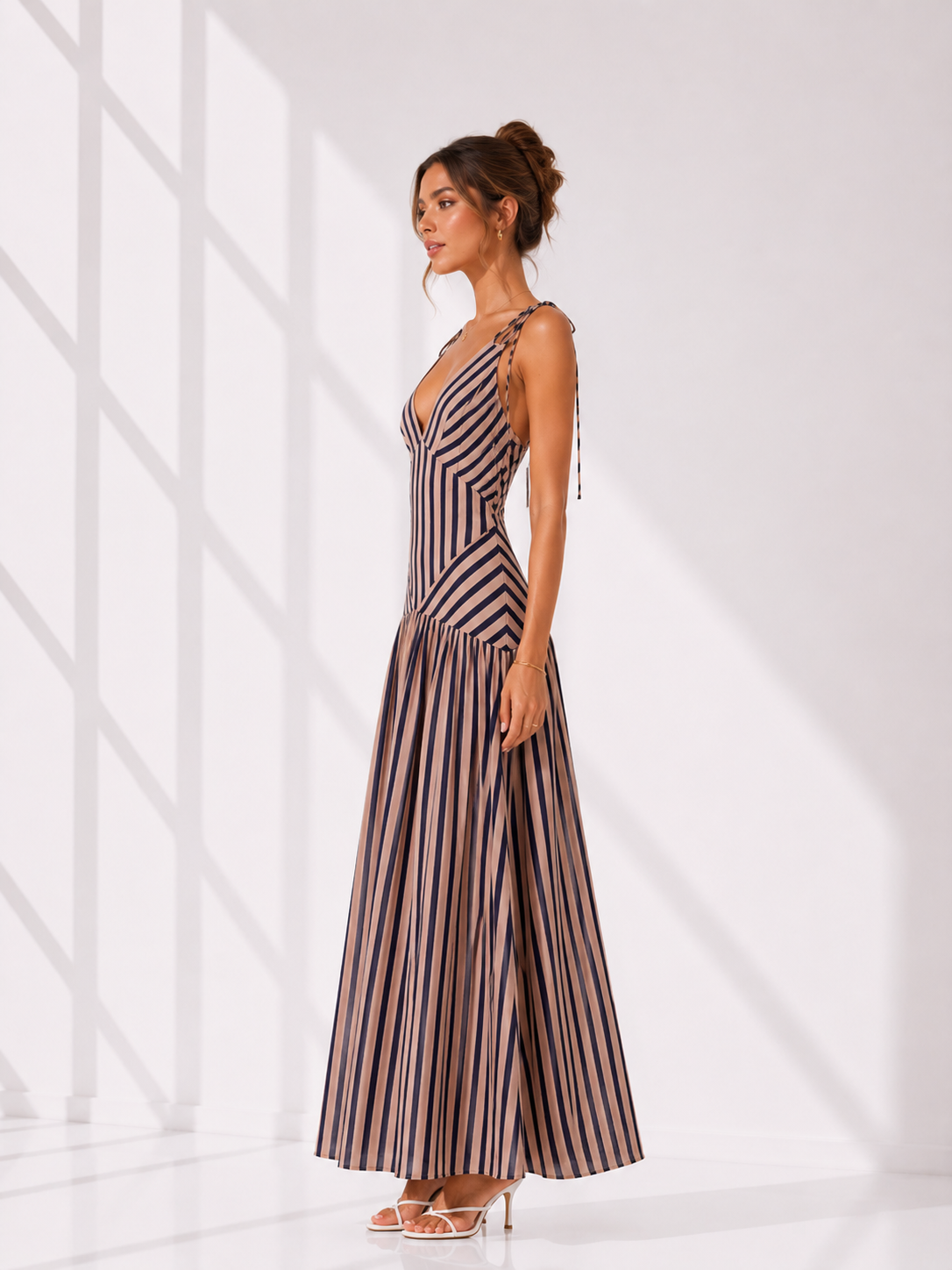 Woman wearing a striped dress against a white background