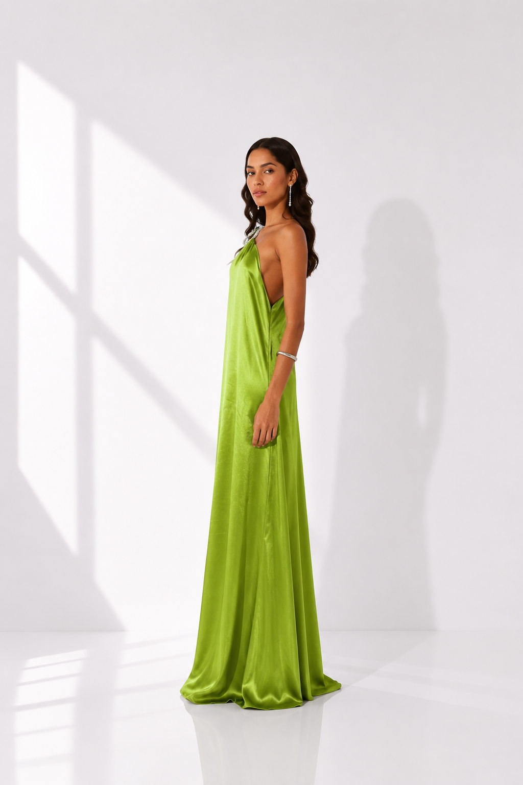 Woman wearing a green evening gown against a white background