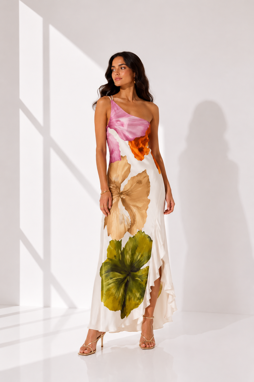 Woman wearing a colorful floral dress in a bright room