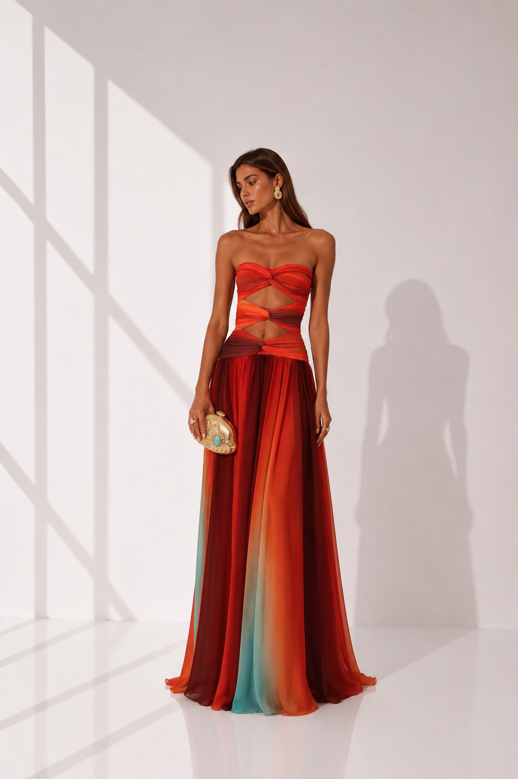 Woman wearing a strapless, multicolored evening gown with a white background