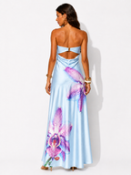 Woman wearing a light blue dress with floral designs on a white background