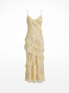 Yellow floral dress with ruffled layers on a white background