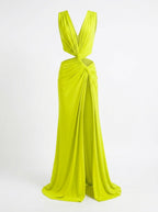 Lime green evening gown with a deep neckline and side draping on a white background