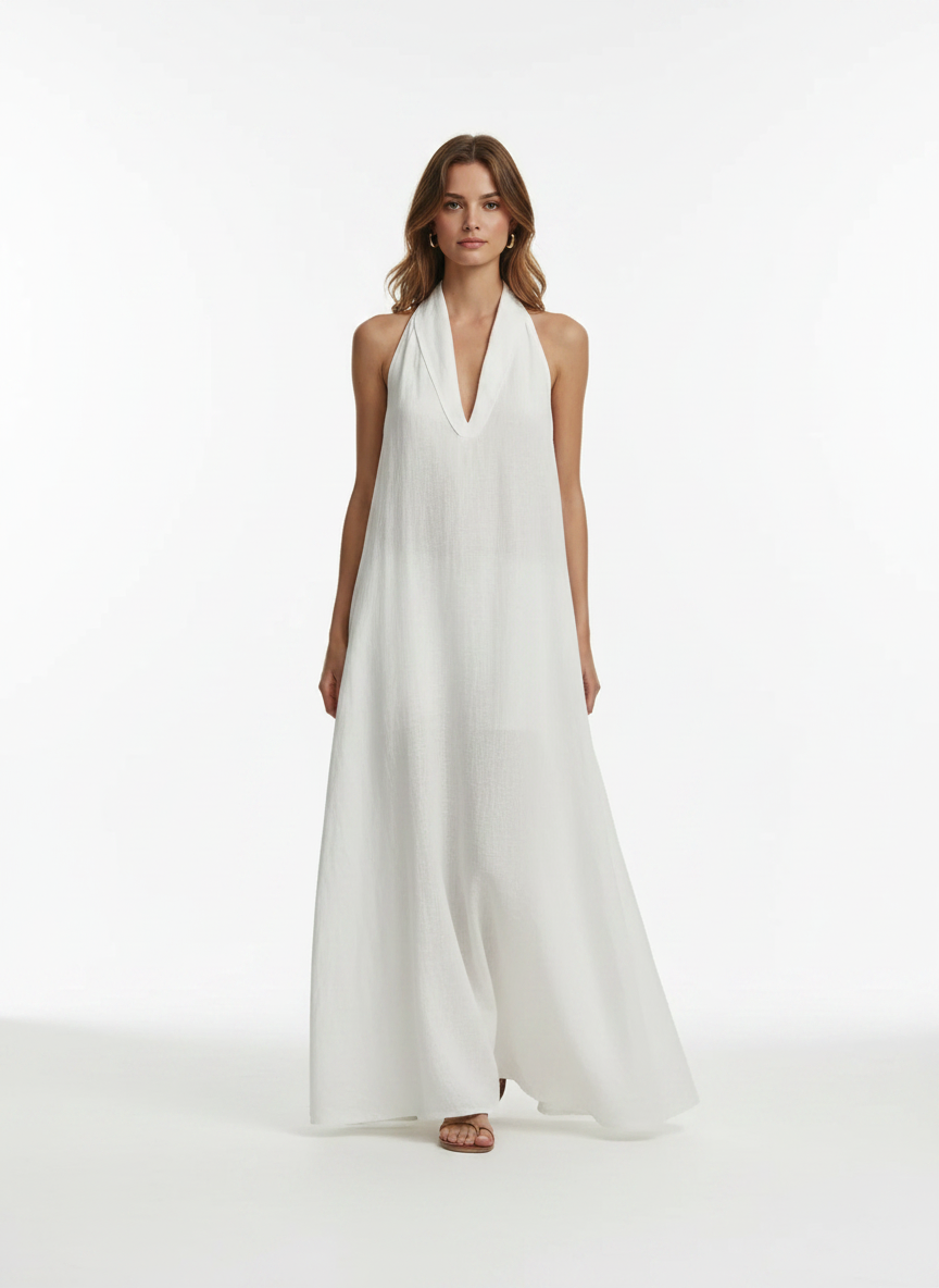 Woman wearing a white halter neck dress on a white background